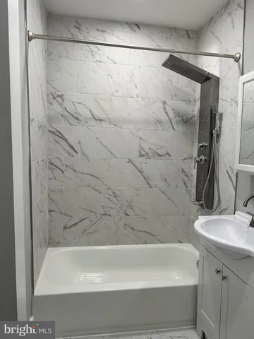 a bathroom with a shower and a sink