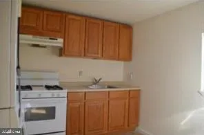 a kitchen with a sink cabinets and appliances