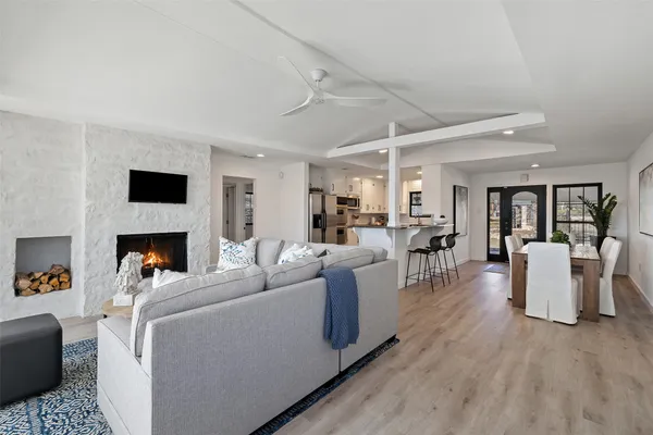 a living room with furniture a fireplace and a flat screen tv