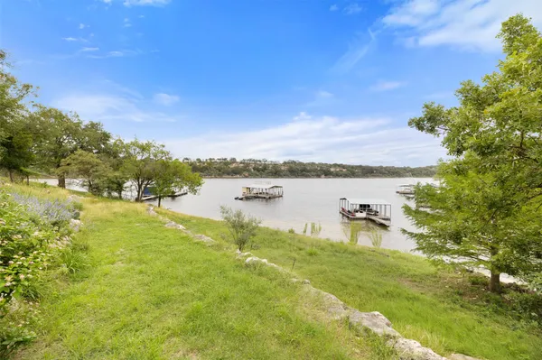 a view of a lake with houses in the background