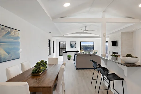 a living room with furniture and view of kitchen