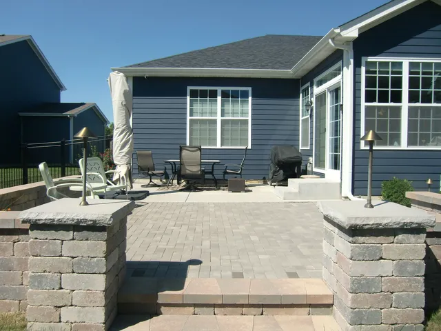 a front view of a house with a yard table and chairs