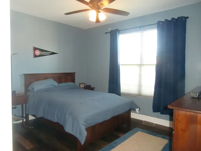 a bedroom with a bed and window