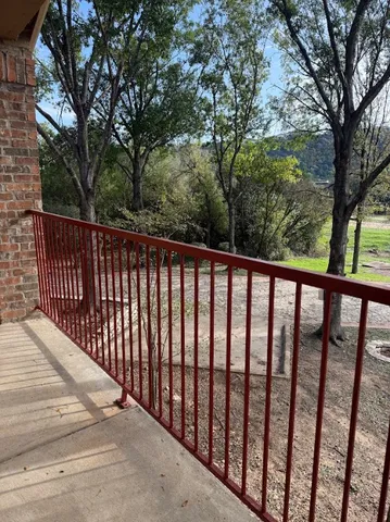 a balcony with trees in front of it