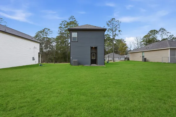 a house that has a big yard with wooden fence