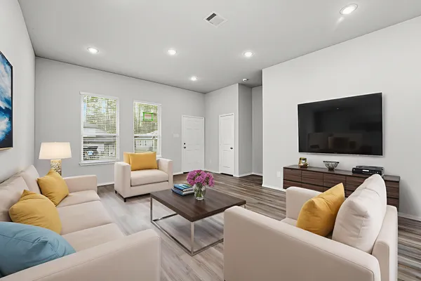 a living room with furniture and a flat screen tv