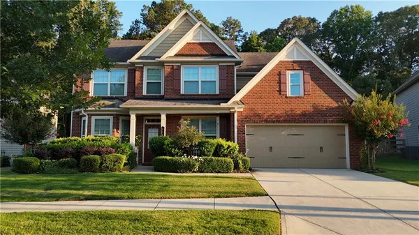 a front view of a house with a yard