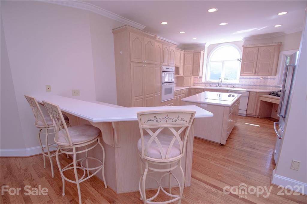 127 Alan Drive Boone, NC 28607 - Photo 21 of 37 a kitchen with stainless steel appliances a dining table chairs and wooden floor