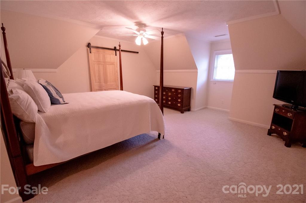 127 Alan Drive Boone, NC 28607 - Photo 32 of 37 a bed room with a bed window and a television