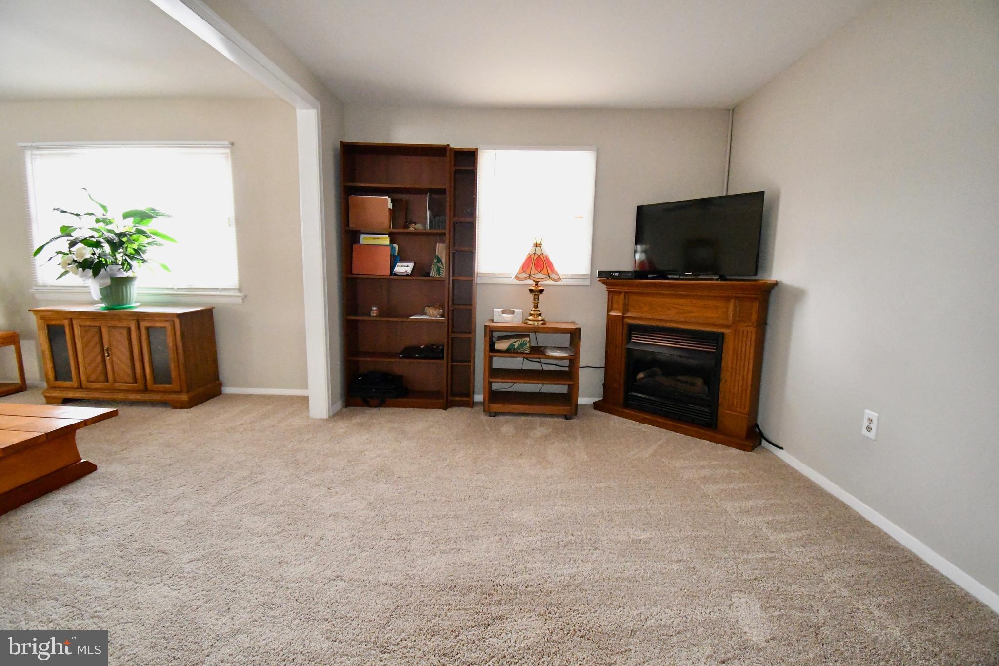 3707 Red Grove Road Baltimore, MD 21220 - Photo 6 of 32 an empty room with furniture and a flat screen tv