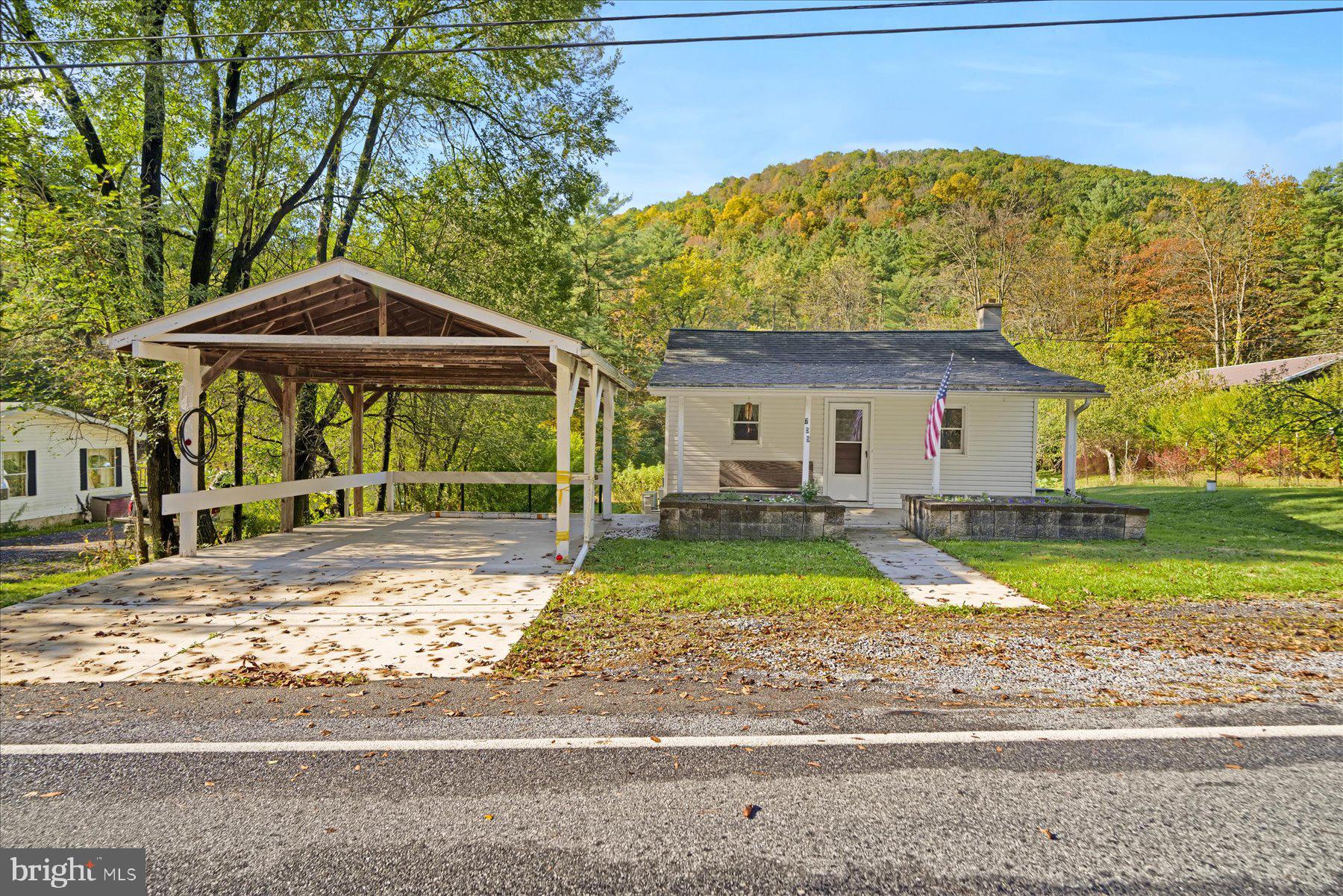 a view of a house with a yard and sitting area