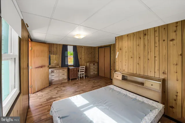 a spacious bedroom with a large window and a table