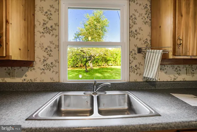 a kitchen with a sink and a window