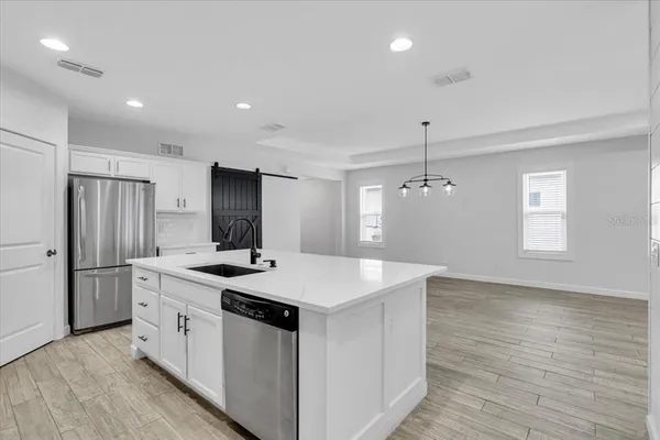 a kitchen with sink and mirror