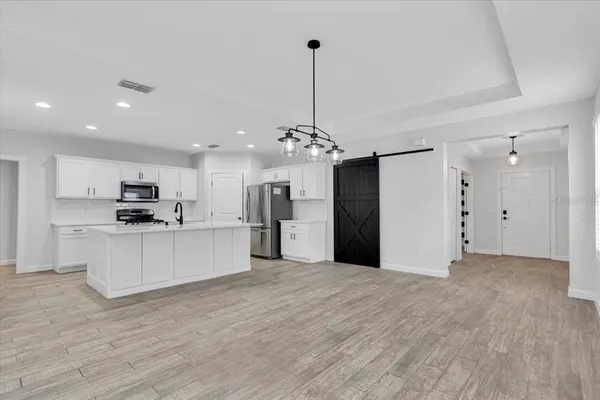 a view of kitchen with refrigerator and window