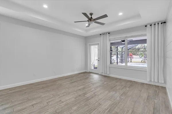 wooden floor in an empty room with a window