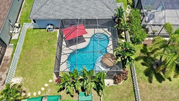 an aerial view of residential houses with outdoor space and river view