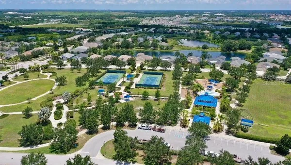 an aerial view of a house with a swimming pool yard and outdoor seating