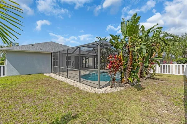 a view of an empty room with a fireplace and a ceiling fan