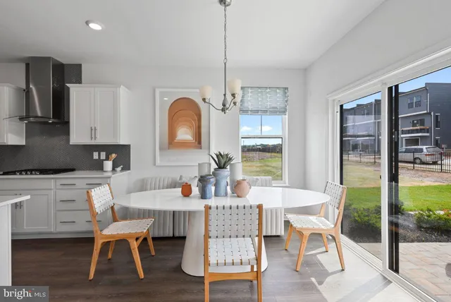 a dining room with furniture and wooden floor