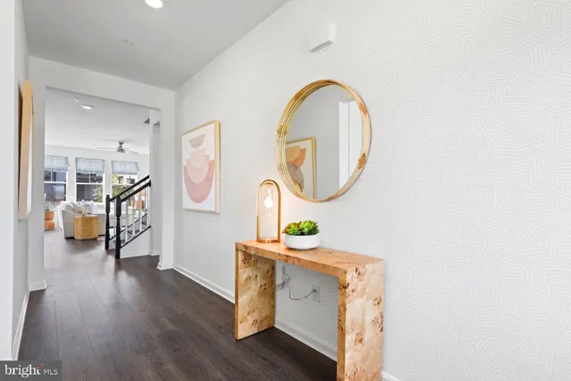 a view of a hallway with wooden floor and entryway