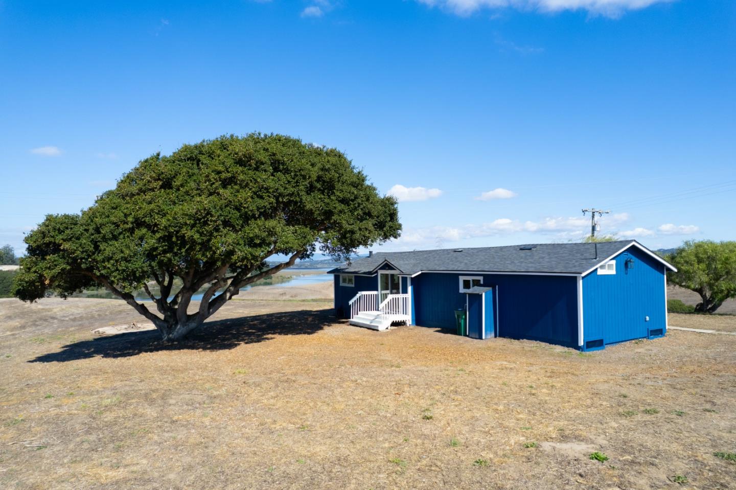 13265 Avila Road Castroville, CA 95012 - Photo 13 of 31 a view of a backyard with a barn and large tree