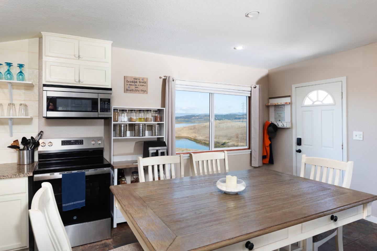 13265 Avila Road Castroville, CA 95012 - Photo 17 of 31 a kitchen with stainless steel appliances wooden floor dining table and chairs