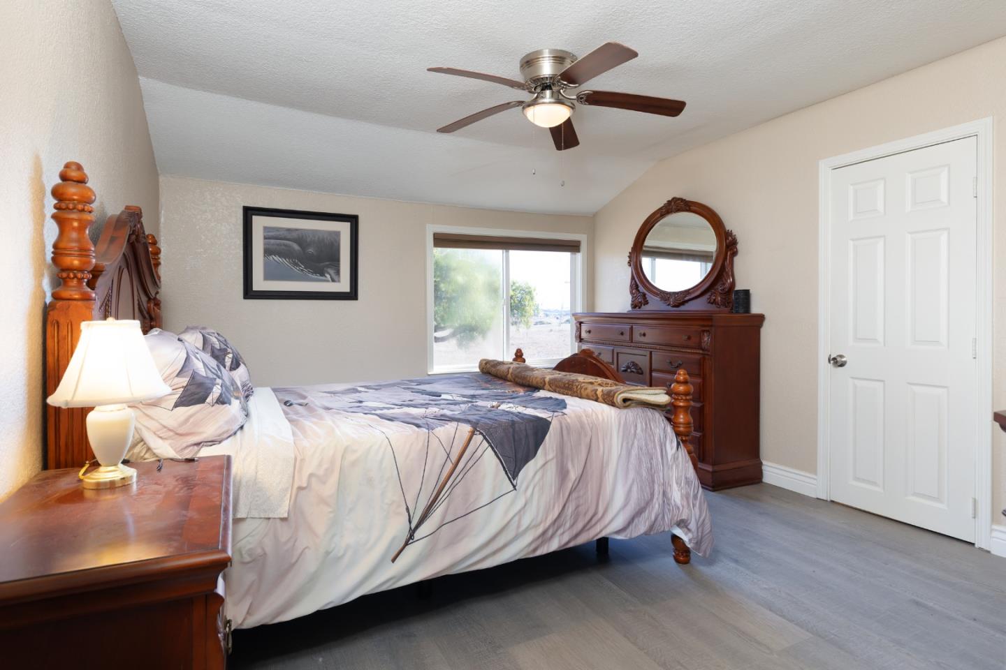 13265 Avila Road Castroville, CA 95012 - Photo 21 of 31 a bedroom with a bed and a chandelier