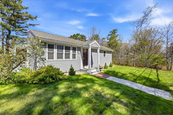 a view of a house with a backyard