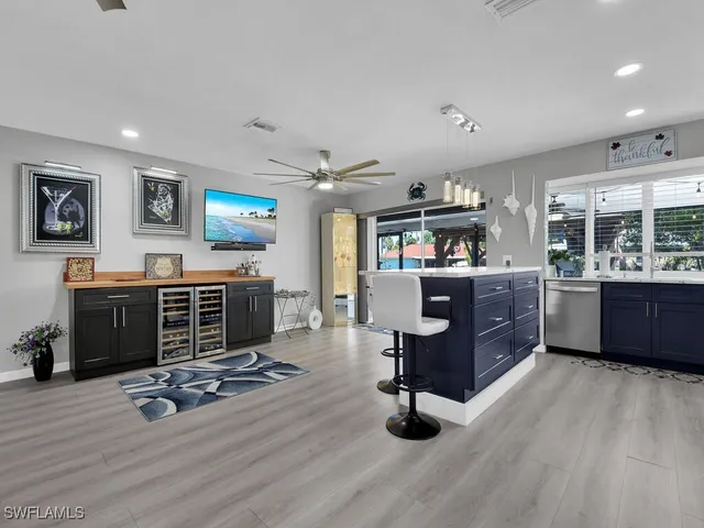 a room with lots of wooden furniture and windows