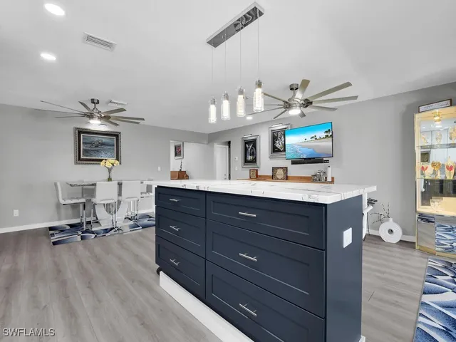 a room with a bed cabinets and flat screen tv