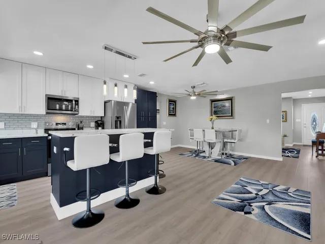 a living room with furniture and kitchen view