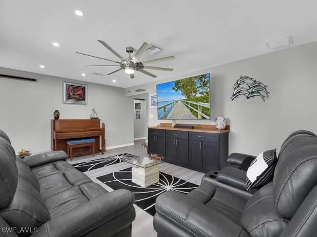 a living room with furniture a couch and a chandelier