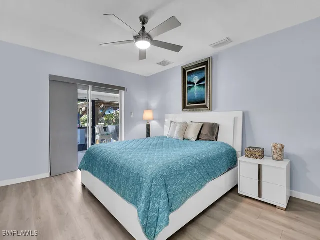 a bedroom with a large bed and a chandelier