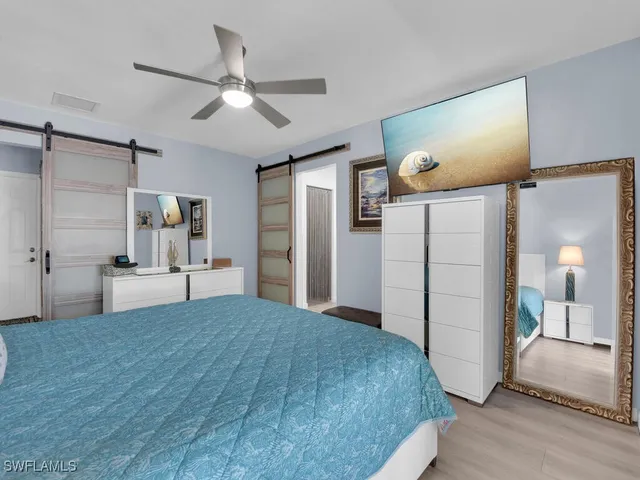 a spacious bedroom with a bed and a walk in closet