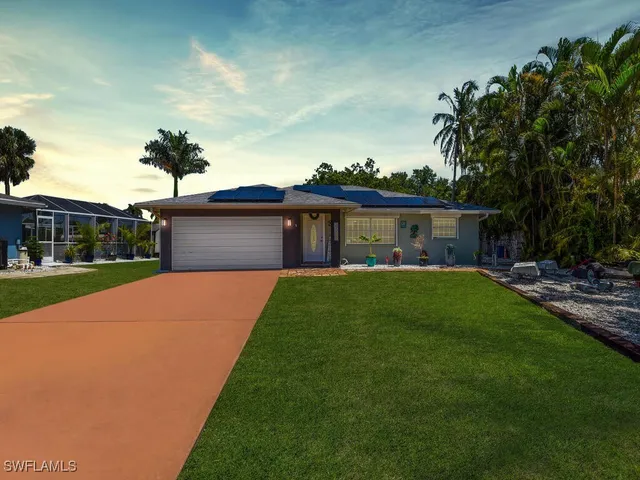 a front view of house with yard and green space