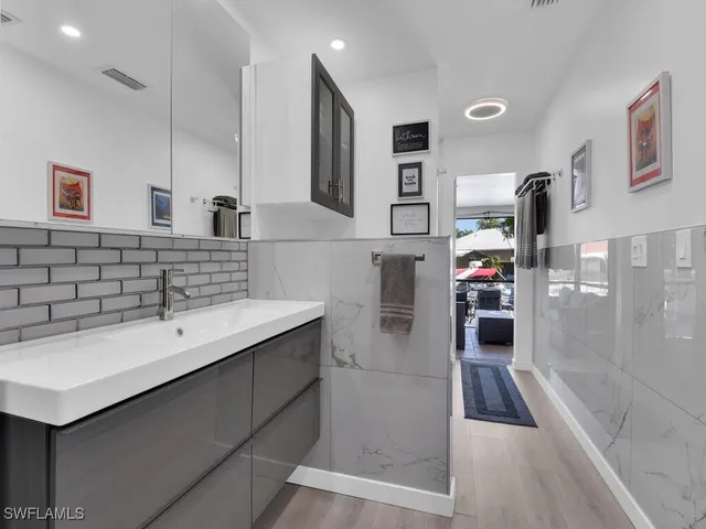 a bathroom with a sink and mirror