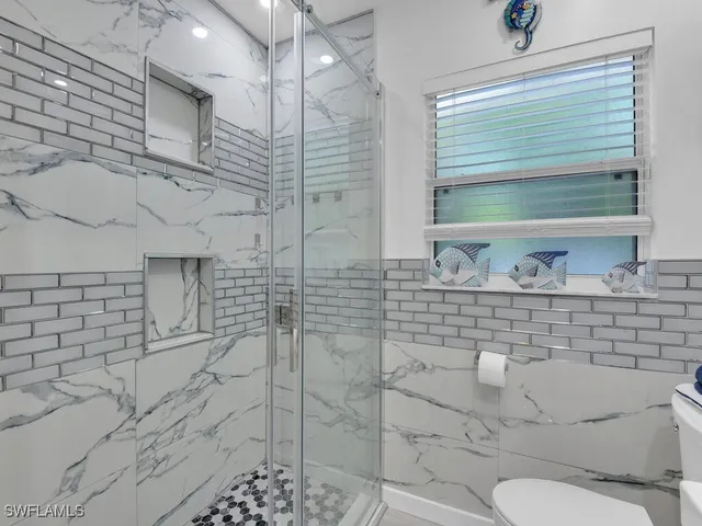 a bathroom with a toilet sink and shower