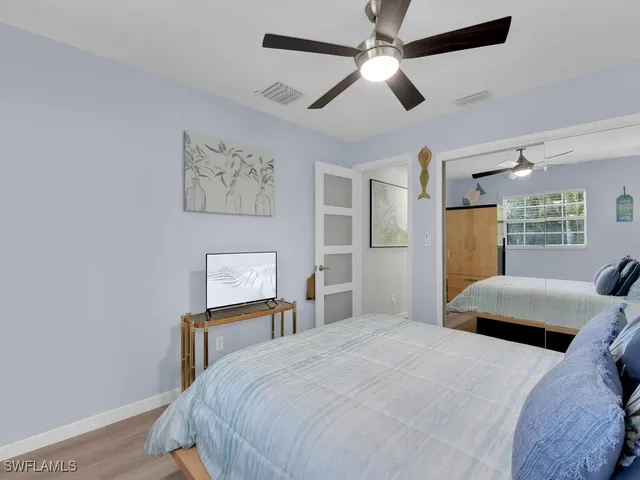 a bedroom with a large bed and a chandelier