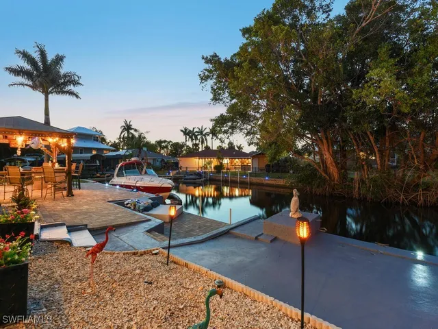 a view of a swimming pool with a lounge chair and tables