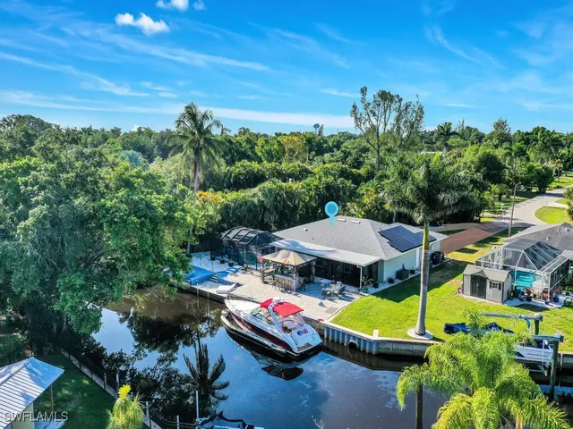 an aerial view of a swimming pool patio and outdoor seating