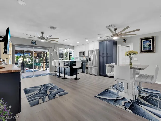 a living room with furniture gym equipment and a large window