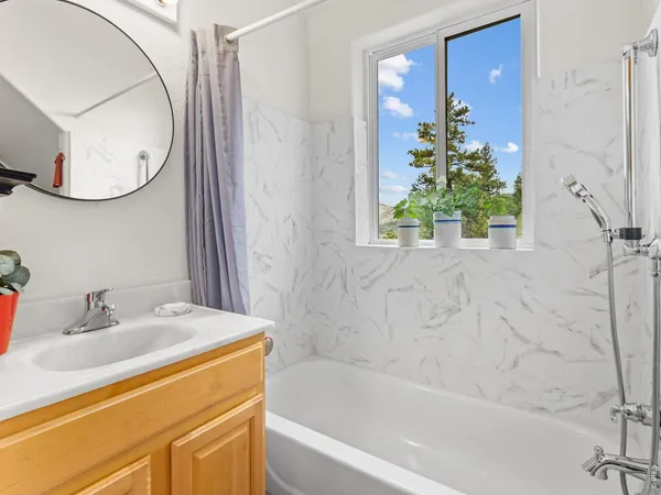 a bath room with a sink and a mirror