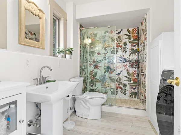 a bathroom with a sink toilet and shower