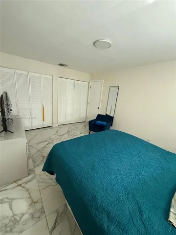 a bedroom with a bed and a cabinets