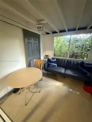 a room with pool table and windows