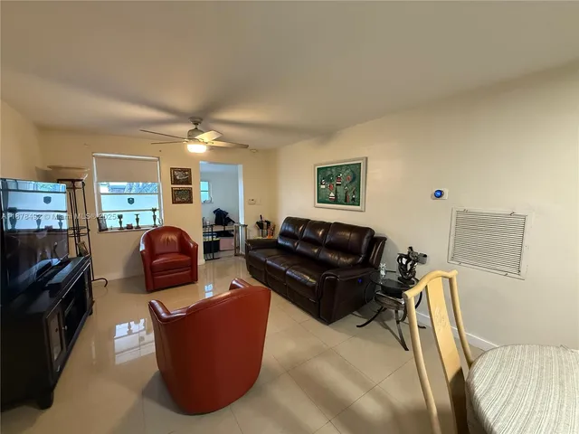 a living room with furniture window and a flat screen tv