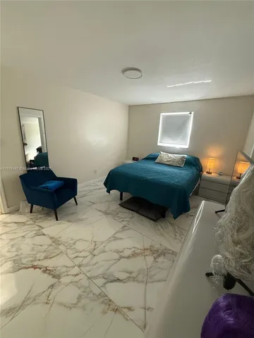 a bedroom with double bed and a window