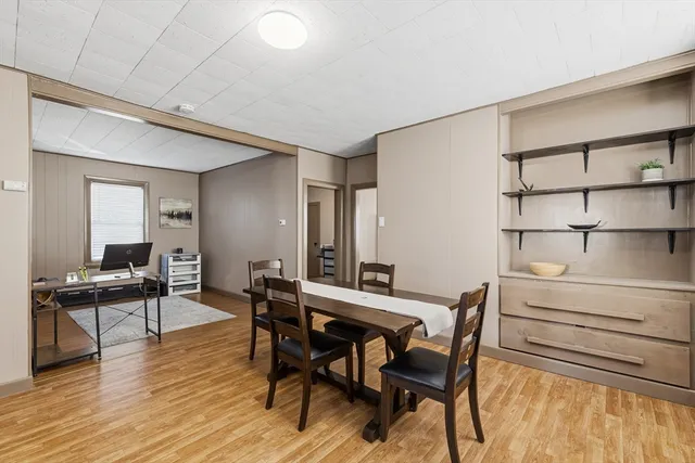 a view of a dining room with furniture and wooden floor
