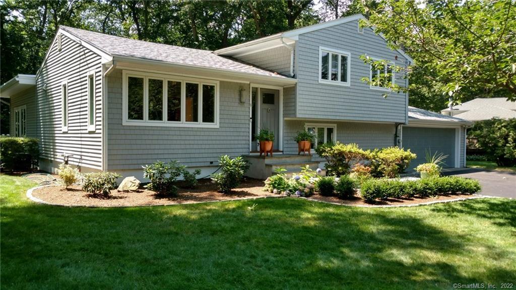 a front view of a house with a garden